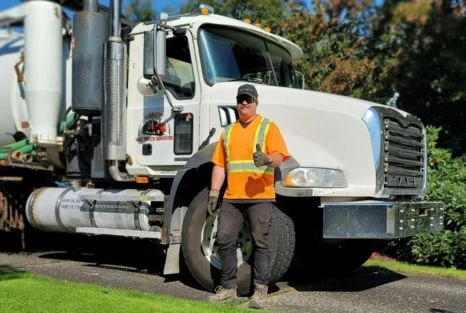 Clearset technician in PPE beside the branded truck, representing planned service and maintenance guidance in Maple Ridge.