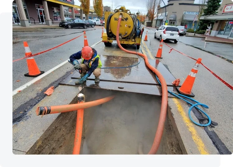 Vac truck crew working with safe jobsite setup and access space for a Maple Ridge septic visit.