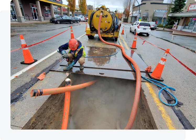 Vac truck staged for septic pumping at a residential Maple Ridge-style property
